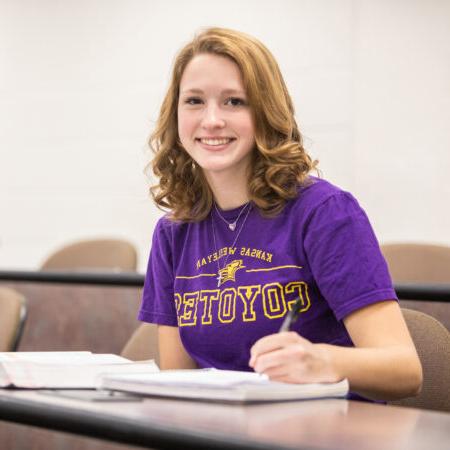 Woman with textbook in classroom